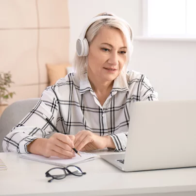 woman listening to and watching online class videos