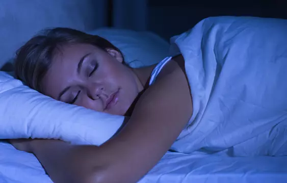 woman sleeping in darkened room